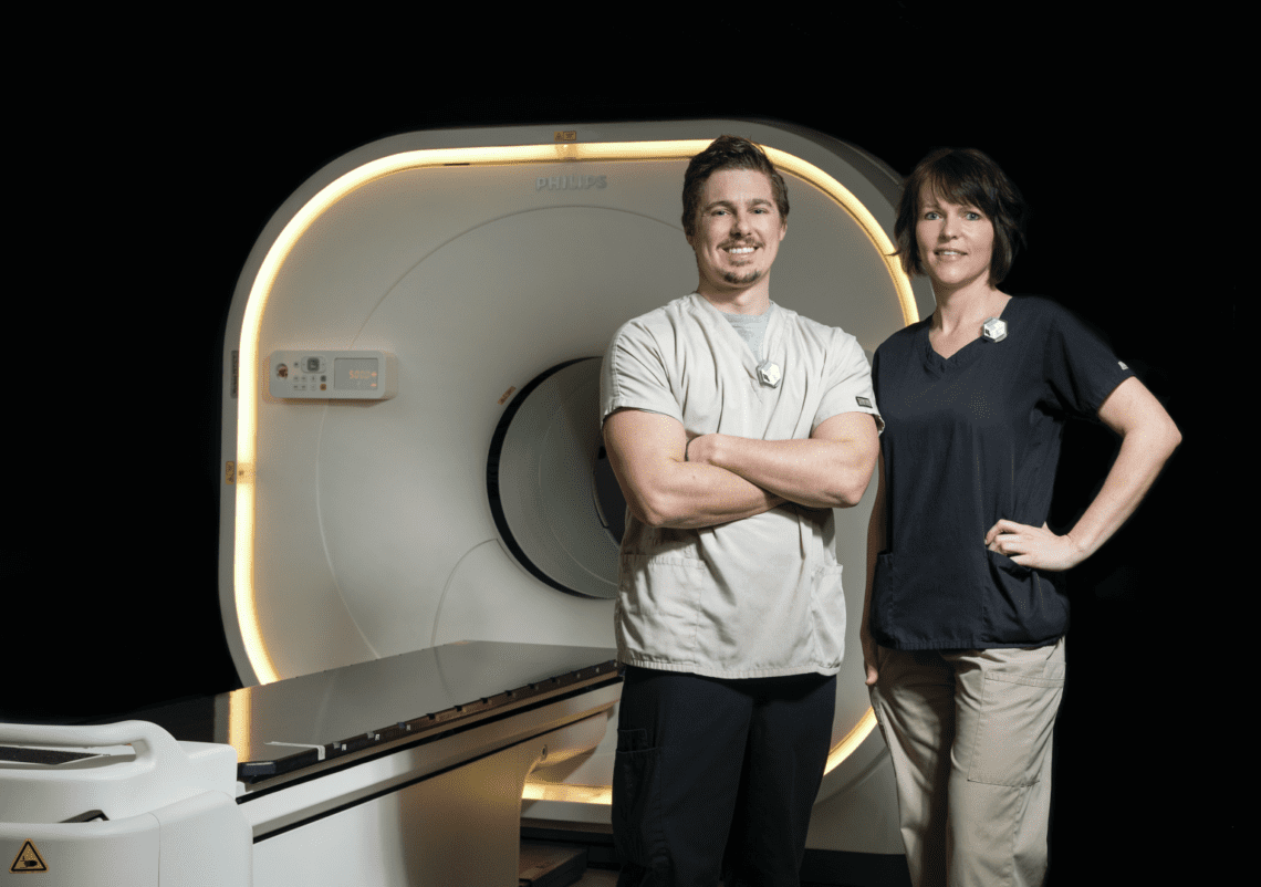 Two Technologists in front of digital pet scanner